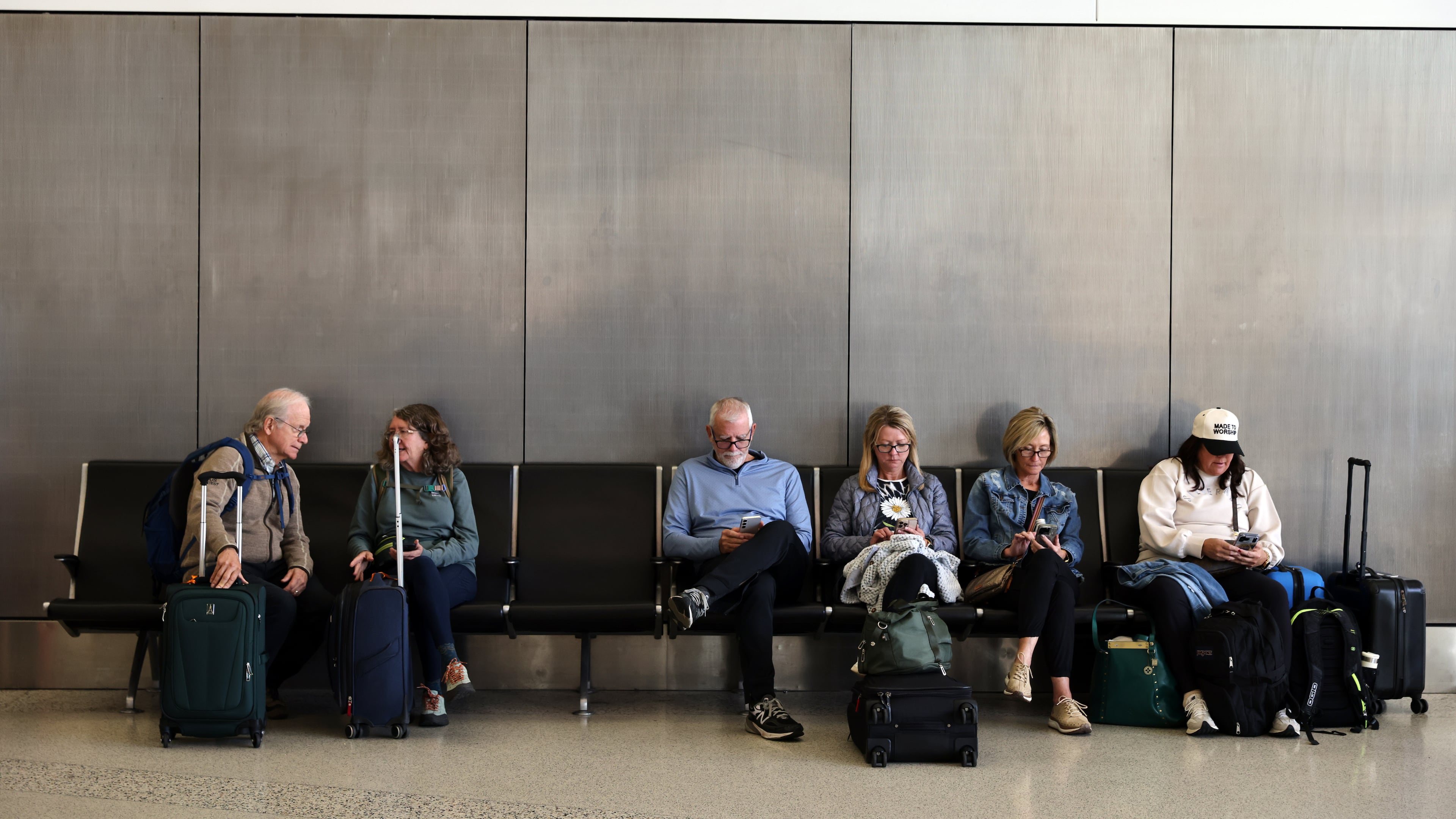 Travelers wait and check for their flights at San Francisco International Airport on Friday, Nov. 7, 2025. (Gabrielle Lurie /San Francisco Chronicle via AP)