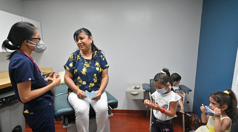 June 24, 2022 Clarkston - Shakhzada Baina Zarova talks to Dr. Esther Kim (left) after her basic dental check up at Ethne Health Clinic in Clarkston on Friday, June 24, 2022. The medical practitioners at Ethne Health, a Clarkston community clinic, say many of their patients suffer from oral health problems. They hope to one day be able to expand and start operating a dental center in the community. (Hyosub Shin / Hyosub.Shin@ajc.com)