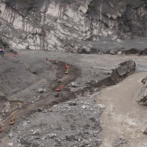 In this photo released by Xinhua News Agency, rescuers use excavators to clear a road at the core area of the mudslide-hit Gyirong Port in Gyirong County, southwestern China's Tibet Autonomous Region, Wednesday, Sept. 2, 2026. (Tenzing Nima Qadhup/Xinhua via AP)