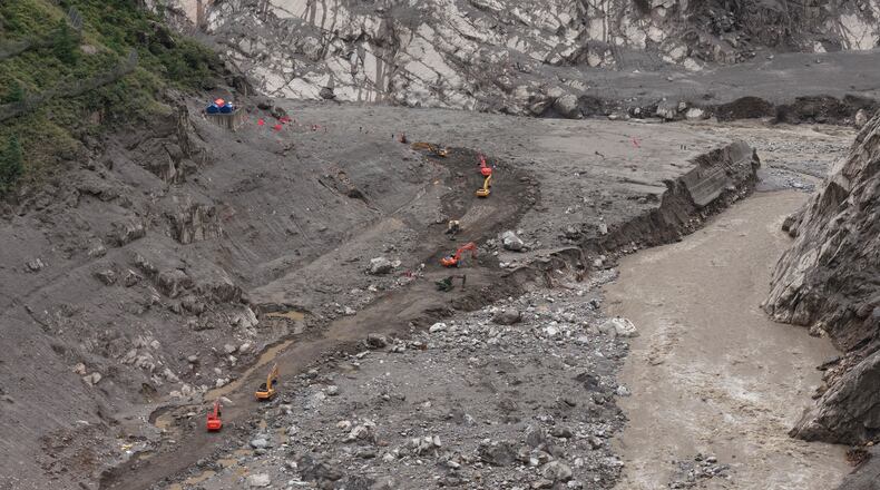 In this photo released by Xinhua News Agency, rescuers use excavators to clear a road at the core area of the mudslide-hit Gyirong Port in Gyirong County, southwestern China's Tibet Autonomous Region, Wednesday, Sept. 2, 2026. (Tenzing Nima Qadhup/Xinhua via AP)