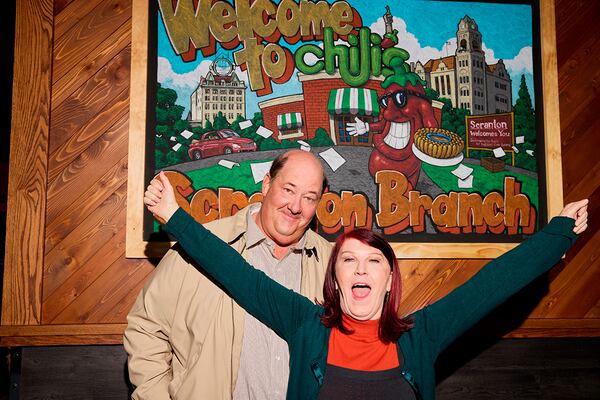 This undated photo released by Chili's shows actors Brian Baumgartner, left, who played Kevin Malone, and Kate Flannery, who played Meredith Palmer in the TV series "The Office," posing for a photo in a soon-to-be opened Chili's in Dickson City, Pa. (Ben Rosenzweig, Chili's via AP)
