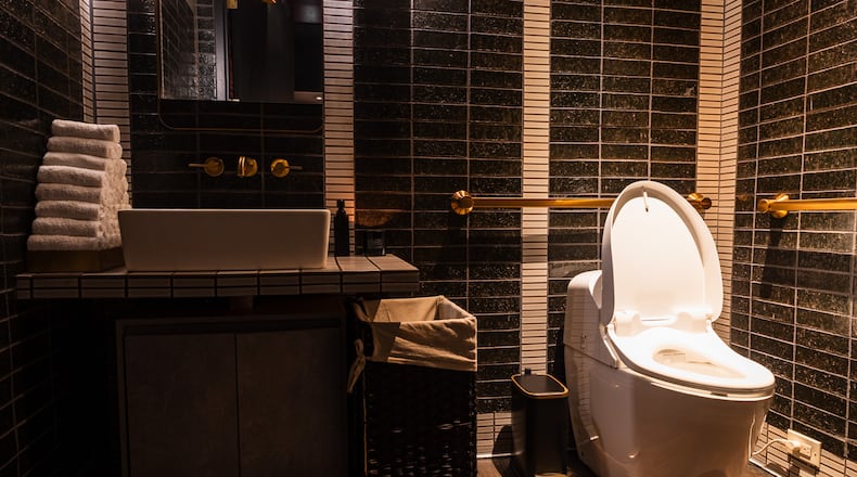 The toilet at Mujo automatically opens when a guest enters the restaurant's single restroom. (Henri Hollis/AJC)