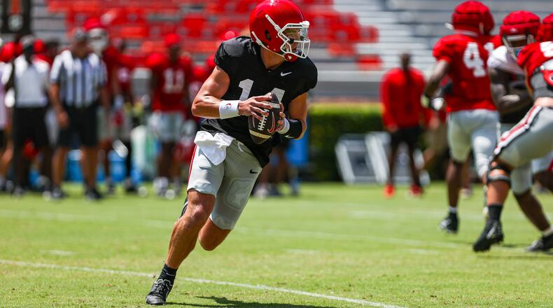 Georgia quarterback Gunner Stockton (14) rolls to the right looking for an open receiver during Georgia’s scrimmage on Dooley Field at Sanford Stadium in Athens, on Saturday, Aug. 19, 2023. (Tony Walsh/UGA Athletics)