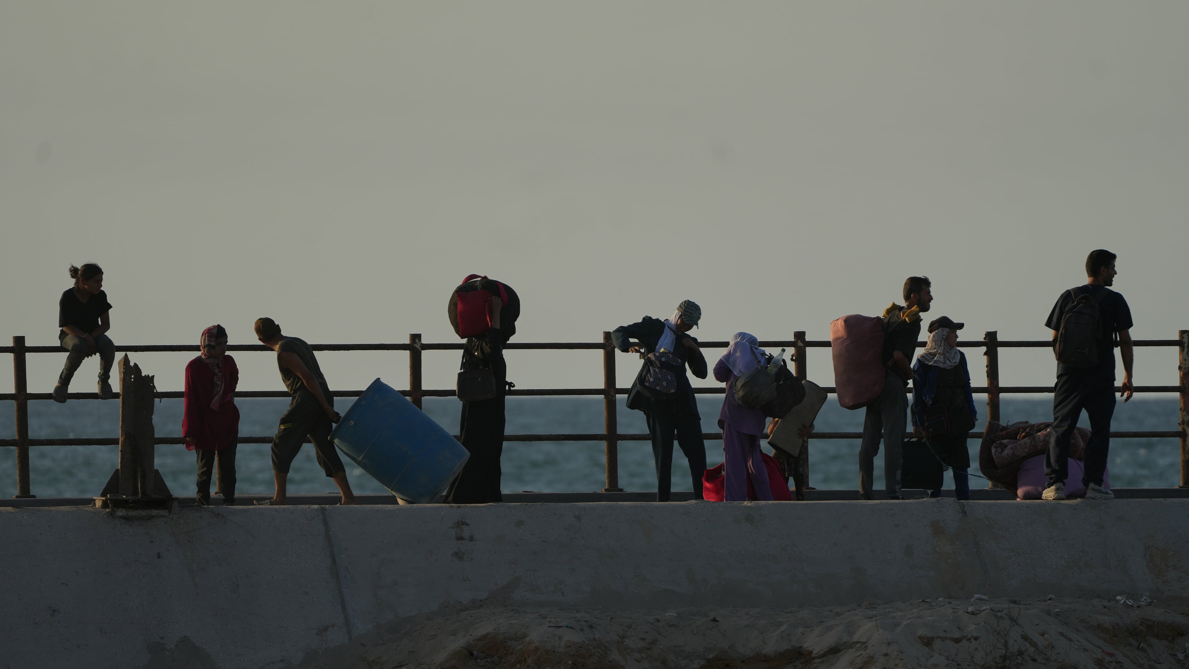 Displaced Palestinians flee northern Gaza carrying their belongings along the coastal road near Wadi Gaza, Thursday, Oct. 2, 2025. (AP Photo/Abdel Kareem Hana)