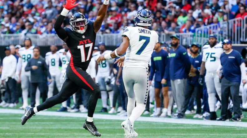Atlanta Falcons linebacker Arnold Ebiketie (17) tries to block Seattle Seahawks quarterback Geno Smith (7) during the second half of an NFL football game against the Seattle Seahawks on Sunday, October 20, 2024, at Mercedes-Benz Stadium in Atlanta. 
(Miguel Martinez/ AJC)