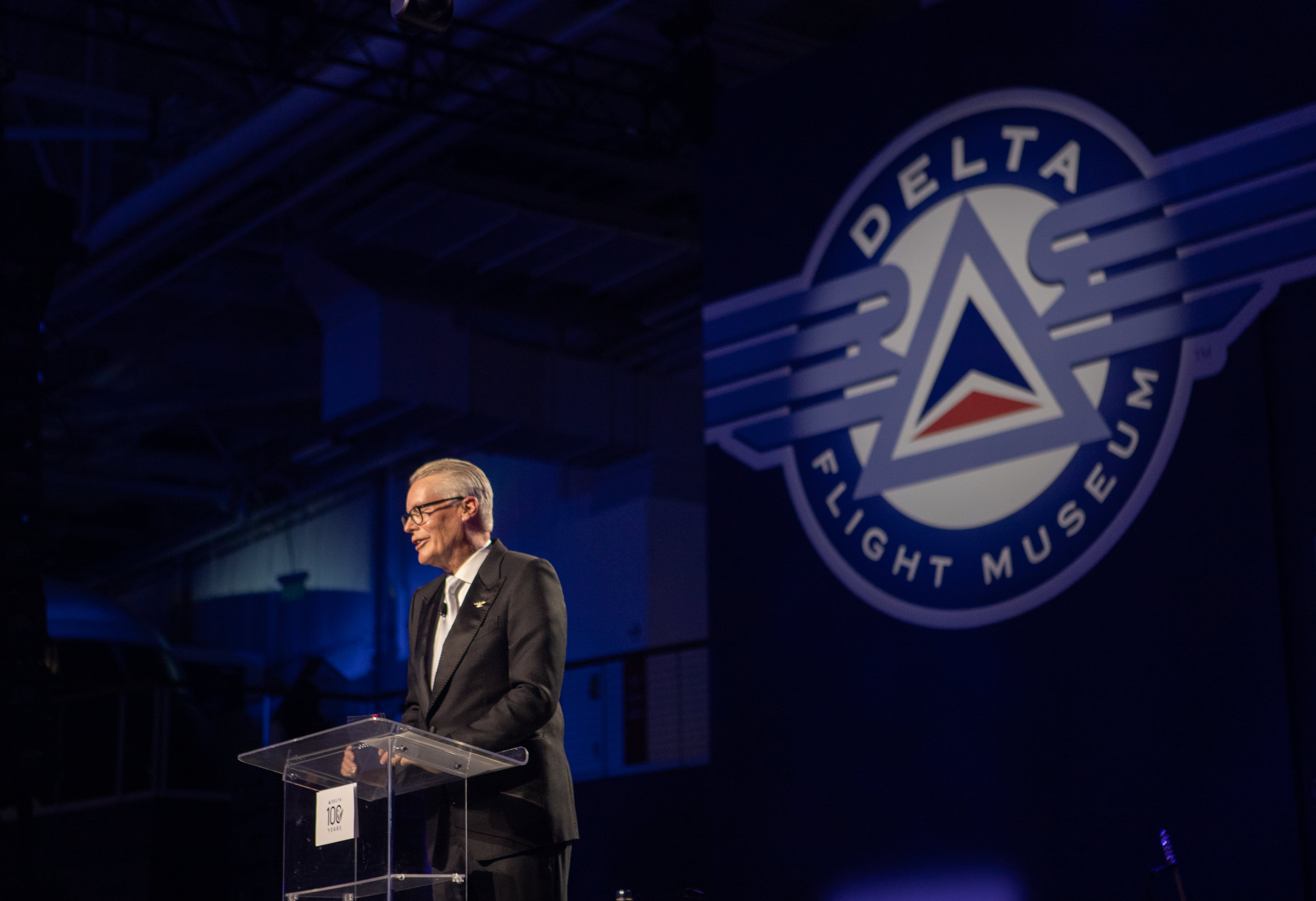 Delta Air Lines CEO Ed Bastian speaks on stage as Delta celebrates its 100 year anniversary on Saturday, March 15, 2025 at the Delta Flight Museum. (Jenni Girtman for the AJC)
