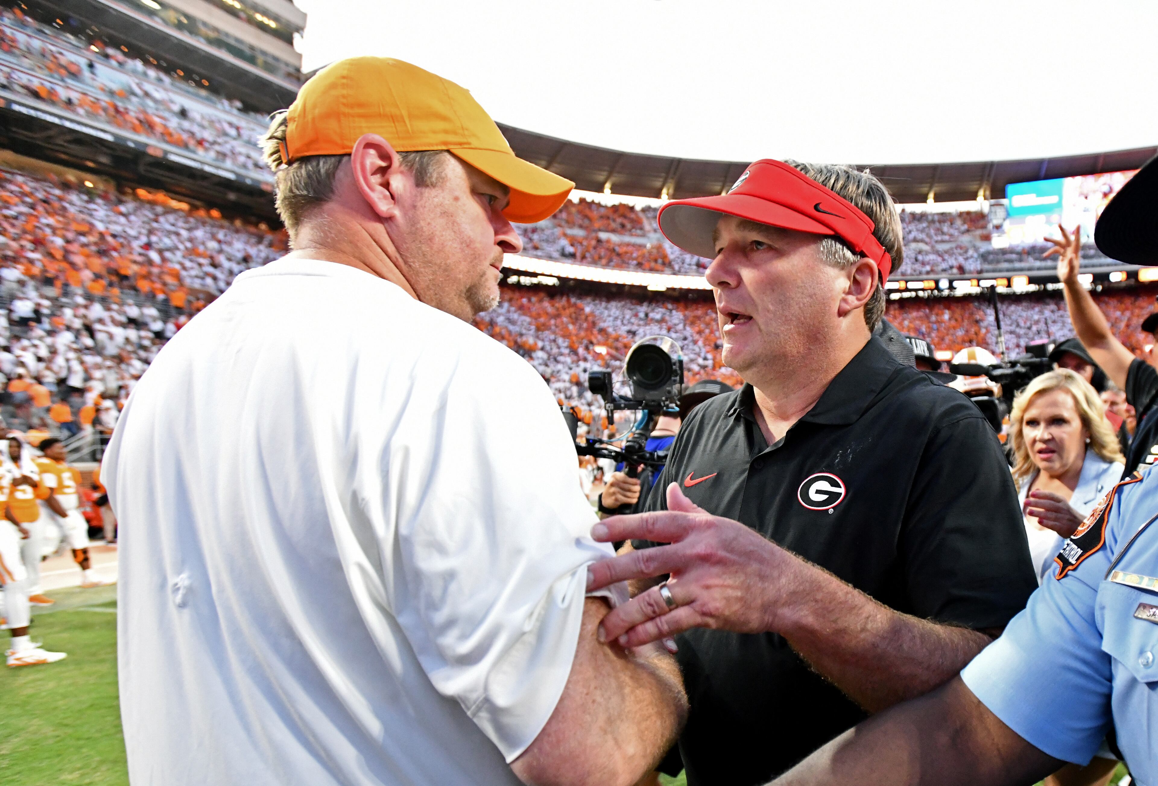 Georgia coach Kirby Smart (right) and Tennessee coach Josh Heupel shake hands after Georgia beat Tennessee in overtime at Neyland Stadium on Saturday, Sept. 13, 2025, in Knoxville, Tenn. (Hyosub Shin/AJC)