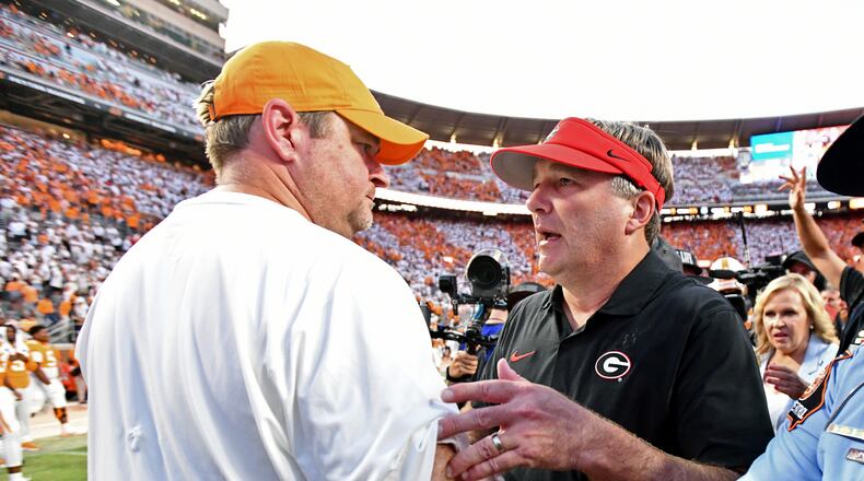 Georgia coach Kirby Smart and Tennessee coach Josh Heupel shake hands after the Bulldogs won in overtime at Neyland Stadium on Saturday, Sept. 13, 2025, in Knoxville, Tenn. (Hyosub Shin/AJC)