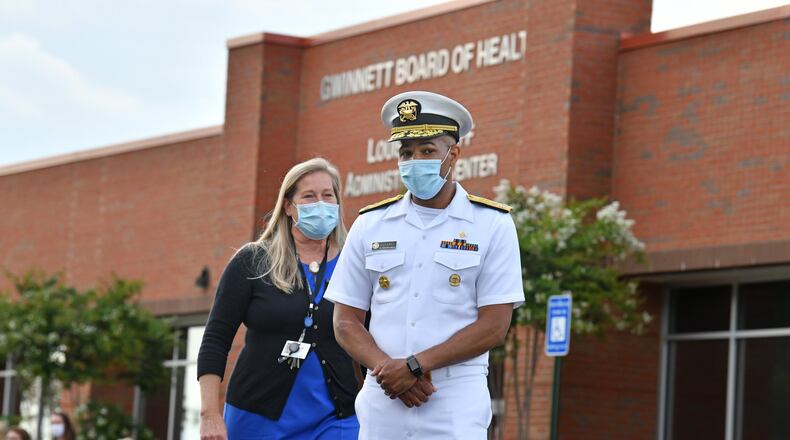 July 2, 2020 Lawrenceville - U.S. Surgeon General Jerome Adams (right) and Gwinnett Newton Rockdale Health Director Audrey Arona walk to the podium for a press conference amid a rise in coronavirus cases in Gwinnett County outside the Louise Radloff Administrative Building in Lawrenceville on Thursday, July 2, 2020. U.S. (Hyosub Shin / Hyosub.Shin@ajc.com)