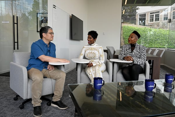 Pinky Cole (right) — pictured speaking with castmate Shamea Morton (center) to AJC reporter Rodney Ho — said of going through Slutty Vegan's bankruptcy while filming the show: " … I truly believe God wanted me to be a vessel to be able to utilize my testimony to educate other people about bankruptcy." (Hyosub Shin/AJC)