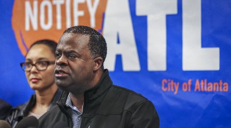 Ria C. Aiken, director of emergency preparedness (left), listens to Mayor Kasim Reed (right) during a press conference at Atlanta Public Safety headquarters on Friday.