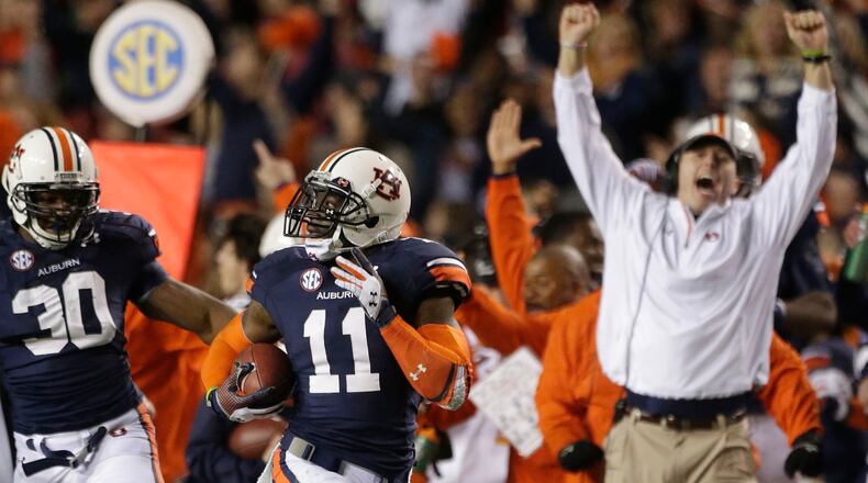 Auburn cornerback Chris Davis (11) returns a missed field goal attempt 100-plus yards to score the game-winning touchdown as time expired in the fourth quarter of an NCAA college football game against No. 1 Alabama in Auburn, Ala., Saturday, Nov. 30, 2013. Auburn won 34-28. (AP Photo/Dave Martin)