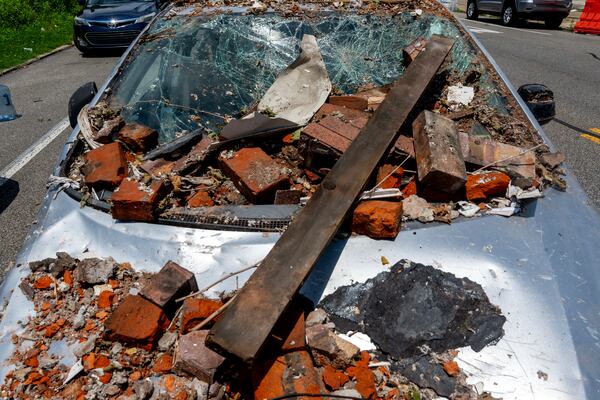 A damaged vehicle remains nearby in the Nicetown area of Philadelphia, Sunday, Jun. 29, 2025, where there were fatalities after three row houses collapsed after a fire and explosion. (Tom Gralish/The Philadelphia Inquirer via AP)