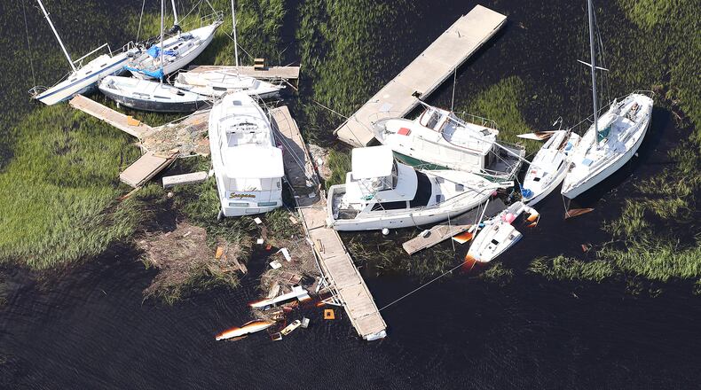 Boats blown away from their docks sit in the marsh after Hurricane Irma in St. Marys on the Georgia’s coast.    Curtis Compton/ccompton@ajc.com