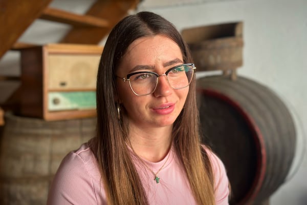 Aliz Alamorean, 23, who recently moved back to Romania after living in Spain since she was five, speaks during an interview with the Associated Press, at the preserves factory where she works in the village of Saschiz, in Romania's central Transylvania region, Friday, April 25, 2025. (AP Photo/Stephen McGrath)