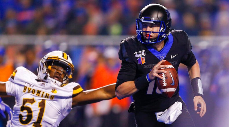 Boise State quarterback Chase Cord (10) runs just out of reach of Wyoming defensive end Solomon Byrd (51) during the second half of an NCAA college football game Saturday, Nov. 9, 2019, in Boise, Idaho. Boise State won 20-17. (AP Photo/Steve Conner)