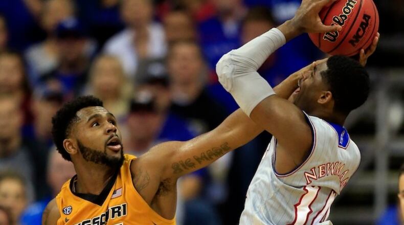 Missouri forward Kevin Puryear (24) and Kansas guard Malik Newman (14) during the second half of an exhibition NCAA college basketball game in Kansas City, Mo., Sunday, Oct. 22, 2017. Kansas defeated Missouri 93-87. (AP Photo/Orlin Wagner)