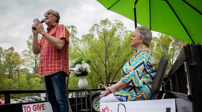 Pastor Shell Osbon and his wife Missy, talk to the crowd during the Drive-in church service at the Life Church Smyrna Assembly of God Sunday, April 5, 2020. STEVE SCHAEFER / SPECIAL TO THE AJC