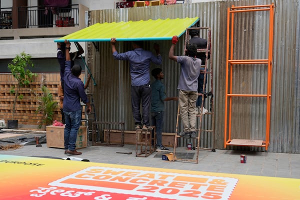 Workers install Neralu, an innovative portable heat shelter, ahead of the Sweat and Concrete 2025 event in Bengaluru, India, Wednesday, May 28, 2025. (AP Photo/Aijaz Rahi)