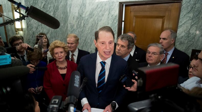 Sen. Ron Wyden, D-Ore., ranking member of the Senate Finance Committee, center, accompanied by, from left, Sen. Debbie Stabenow, D-Mich., Sen. Bill Nelson, D-Fla., Sen. Sherrod Brown, D-Ohio, Sen. Robert Menendez, D-N.Y. and Sen. Bob Casey, D-Pa., speaks in the hallway on Capitol Hill in Washington, Tuesday, Jan. 31, 2017, to discuss opposition to Human Services Secretary-designate, Rep. Tom Price, R-Ga. (AP Photo/Andrew Harnik)