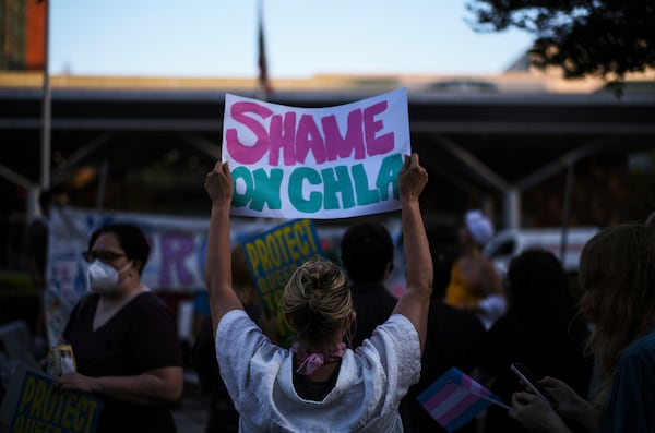 Protesters hold signs while demonstrating against the closure of the trans youth clinic at Children's Hospital Los Angeles, Thursday, July 3, 2025, in Los Angeles. (AP Photo/Jae C. Hong)