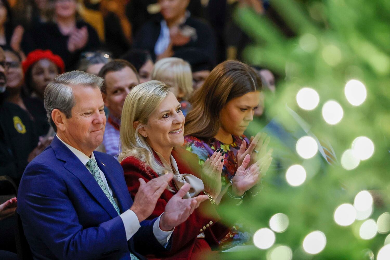 Gov. Brian Kemp and first lady Marty Kemp, along with their daughter Amy Porter Kemp, applaud the Spelman Glee Club during the Christmas Tree Lighting ceremony at the Georgia State Capitol on Monday, Dec. 8, 2025.
(Miguel Martinez/AJC)