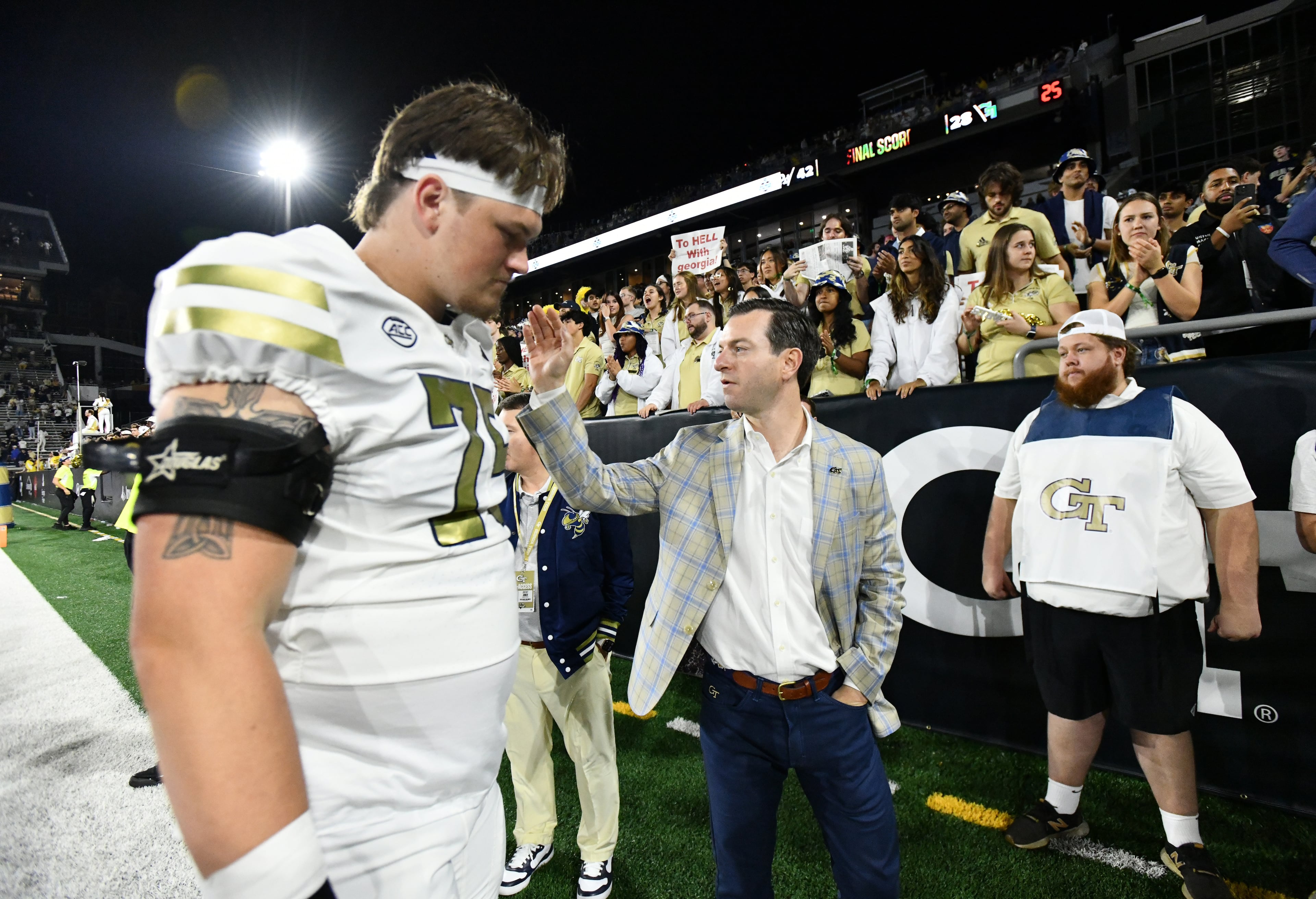 Athletics director Ryan Alpert comforts players after Pittsburgh beat Georgia Tech during an NCAA college football game at Bobby Dodd Stadium, Saturday, November 22, 2025 in Atlanta. Pittsburgh won 42-28 over Georgia Tech. (Hyosub Shin / AJC)