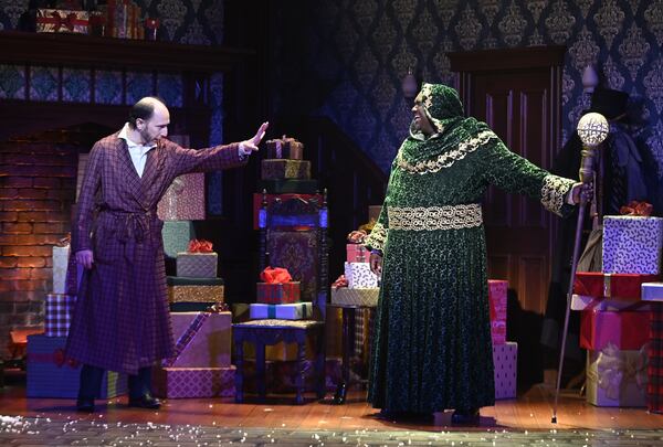 Andrew Benator (left) stars as Ebenezer Scrooge, opposite Brad Raymond as the Ghost of Christmas Present, in the Alliance Theatre’s 34th-annual presentation of “A Christmas Carol,” continuing through Dec. 24.
Courtesy of Alliance Theatre/Greg Mooney