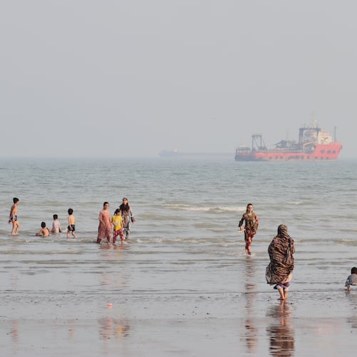 People spend time at a beach as commercial vessels are anchored in the Strait of Hormuz off Bandar Abbas, Iran, Monday, Aug. 31, 2026. (Razieh Poudat/ISNA via AP)