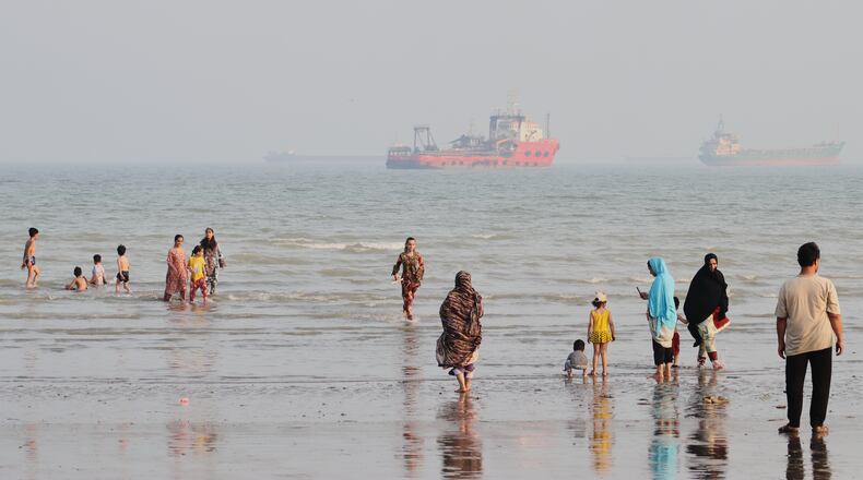 People spend time at a beach as commercial vessels are anchored in the Strait of Hormuz off Bandar Abbas, Iran, Monday, Aug. 31, 2026. (Razieh Poudat/ISNA via AP)