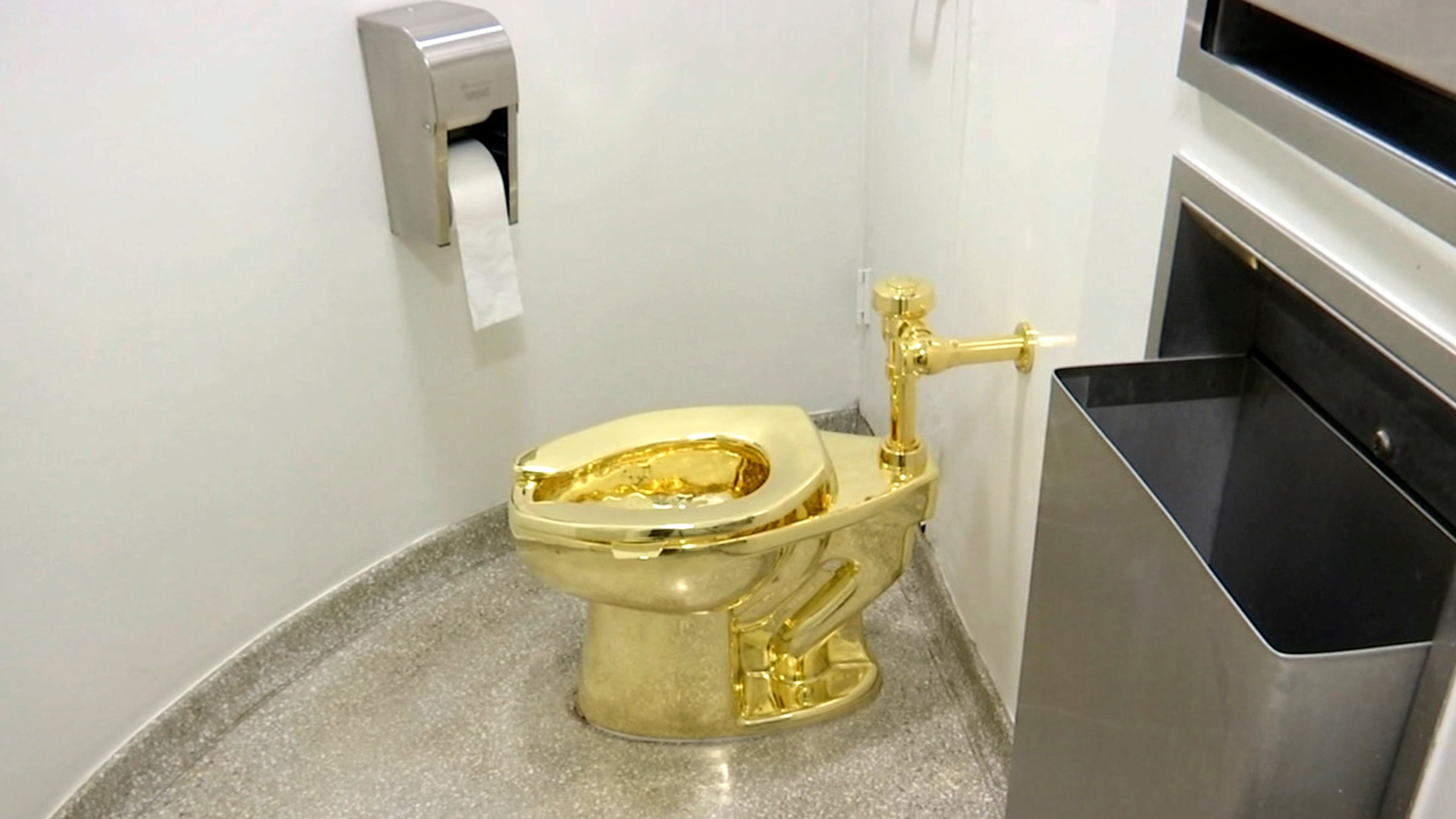 FILE - This Sept. 16, 2016 file image made from a video shows the 18-karat toilet, titled "America," by Maurizio Cattelan in the restroom of the Solomon R. Guggenheim Museum in New York. (AP Photo, File)