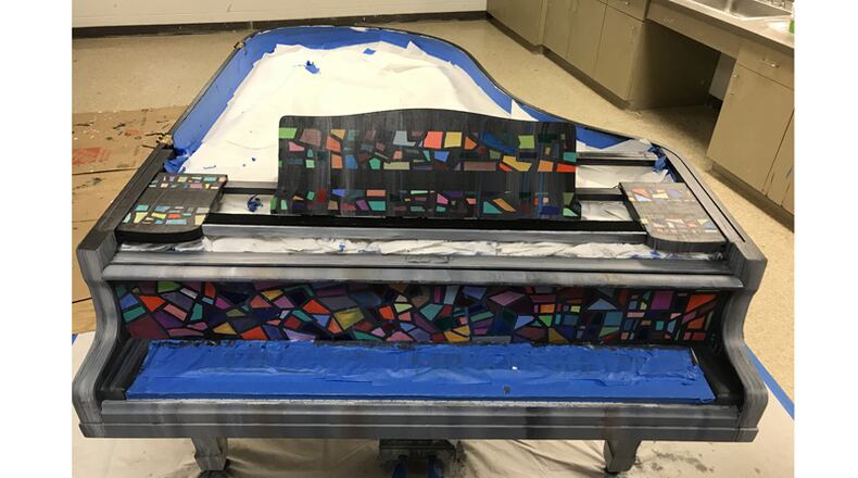 “Ekphrasis,” being painted and prepped as the first baby grand piano installed in a public place by the Play Me Again Pianos nonprofit, is to debut Aug. 24 in Alpharetta. PLAY ME AGAIN PIANOS