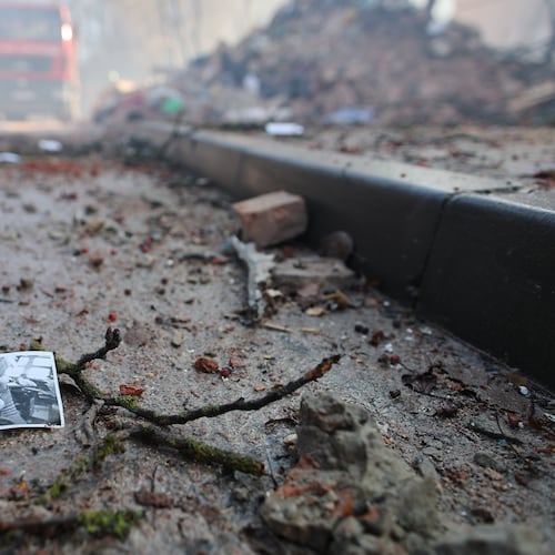 A photograph of a child lies on the ground near a residential building which was heavily damaged by a Russian strike on Ternopil, Ukraine, on Wednesday, Nov. 19, 2025. (AP Photo/Vlad Kravchuk)