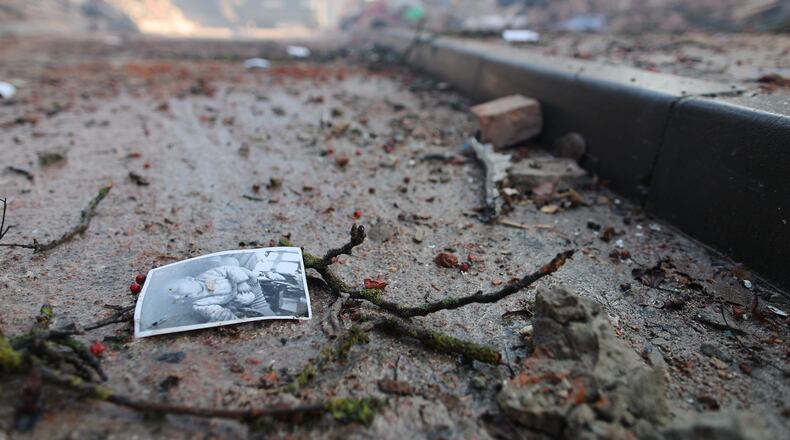 A photograph of a child lies on the ground near a residential building which was heavily damaged by a Russian strike on Ternopil, Ukraine, on Wednesday, Nov. 19, 2025. (AP Photo/Vlad Kravchuk)