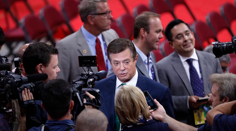 Trump Campaign Chairman Paul Manafort is surrounded by reporters on the floor of the Republican National Convention in Cleveland, Sunday, July 17, 2016. Donald Trump's presidential campaign has hired new staffers to manage the efforts of newly named vice presidential candidate Gov. Mike Pence of Indiana. (AP Photo/J. Scott Applewhite)