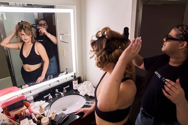 Jae Douglas, 21, a trans femme from Tallahassee, Fla., right, helps Bella Bautista, 22, left, a transgender woman, curl her hair in their hotel room in Arlington, Va., Wednesday, June 4, 2025, as the roommates prepare to attend a dinner for strategic organizers of the National Trans Visibility March, during World Pride. (AP Photo/Jacquelyn Martin)