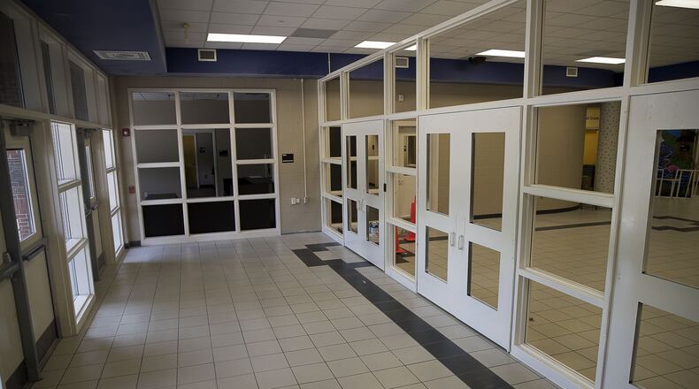 A new security feature, an extra set of doors and a check-in window, are under construction at Johns Creek Elementary School in Suwanee. (ALYSSA POINTER/ALYSSA.POINTER@AJC.COM)
