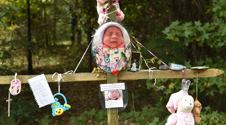 October 13, 2017 Covington - A memorial of flowers and letters is near the area where the newborn's body was found in Covington on Friday, October 13, 2017. Christopher McNabb is accused of killing his 15-day-old newborn inside the home by striking her in the head, according to investigators. Then, he allegedly wrapped her in a blanket and T-shirt, put her in a bag and attempted to hide her under debris, arrest warrants said. McNabb was charged with her death just days after pleading for the baby's return. HYOSUB SHIN / HSHIN@AJC.COM
