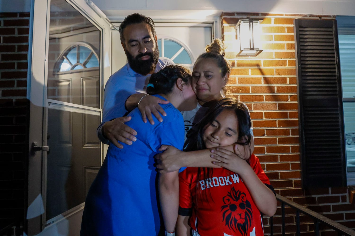 Jose Francisco Arias warmly embraces his wife, Daita Cristobal, and their daughters, Aurora and Daita Arias-Cristobal, following the announcement that their eldest daughter, Ximena Arias-Cristobal, will be leaving the Stewart Immigration Detention Center to return home on Thursday, May 22, 2025. 
(Miguel Martinez/ AJC)