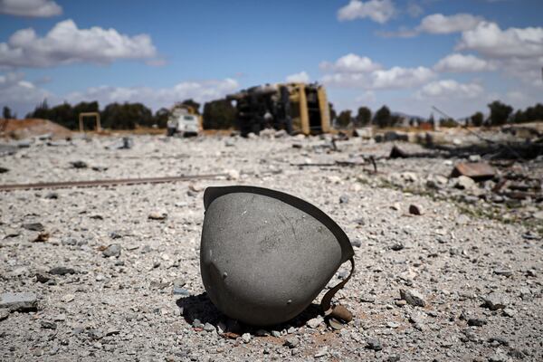A helmet lies among the debris scattered at the site of an Israeli strike on a military airbase near Hama, Syria, Thursday, April 3, 2025. (AP Photo)