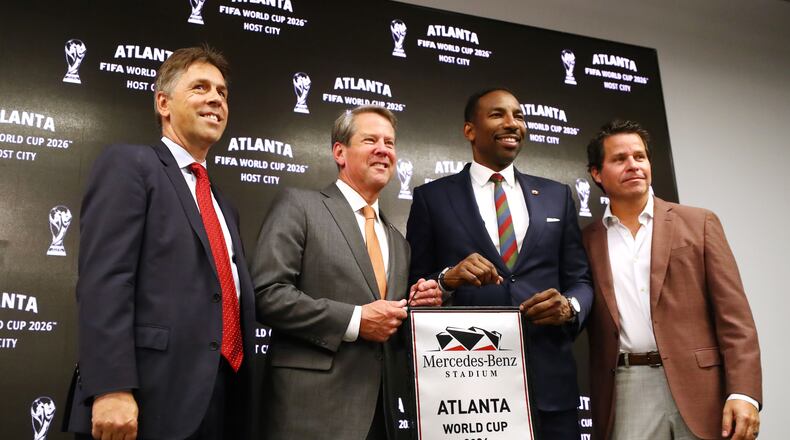 Dietmar Exler, Chief Operating Officer of Mercedes-Benz Stadium, Georgia Governor Brian Kemp, left, Atlanta Mayor Andre Dickens, and Dan Corso of Atlanta Sports Council, take the stage during the Host City announcement press conference for the 2026 World Cup at Mercedes-Benz Stadium on Thursday, June 16, 2022, in Atlanta. (Curtis Compton/The Atlanta Journal-Constitution/TNS)