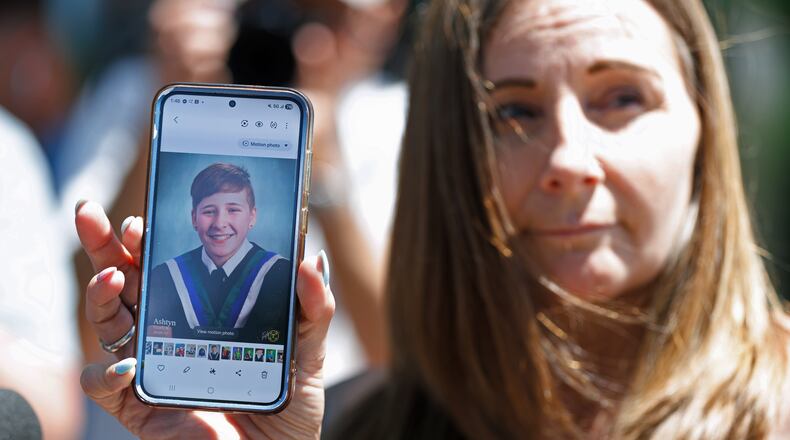 Kim Prosser holds a photo of her son Ashtyn outside the Ontario Court of Justice, Friday, May 29, 2026, in Newmarket, Ontario, after Kenneth Law pleaded guilty to 14 counts of counseling or aiding suicide, including the death of Prosser's son. (Christopher Drost/The Canadian Press via AP)