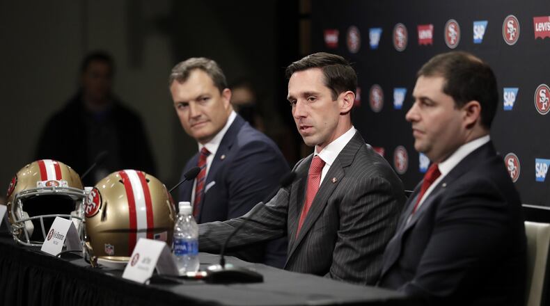 San Francisco 49ers head coach Kyle Shanahan, center, answers questions next to general manager John Lynch, left, and owner Jed York during an NFL football press conference Thursday. (AP Photo/Marcio Jose Sanchez)