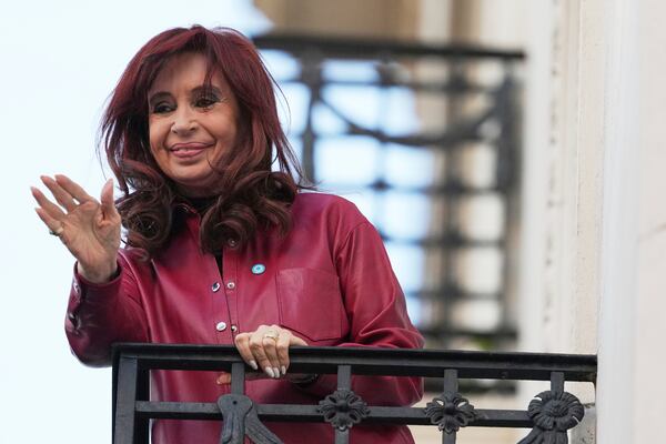 Argentina's former President Cristina Fernandez waves to supporters from her home's balcony two days after Argentina's Supreme Court upheld her corruption conviction in Buenos Aires, Argentina, Thursday, June 12, 2025. (AP Photo/Natacha Pisarenko)