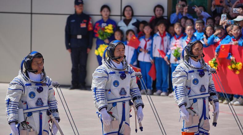FILE - Chinese astronaut for the Shenzhou 20 mission, Chen Dong, center, speaks next to his comrades Chen Zhongrui, right, and Wang Jie as they attend a send-off ceremony for their manned space mission at the Jiuquan Satellite Launch Center in northwestern China, Thursday, April 24, 2025. (AP Photo/Andy Wong, file)