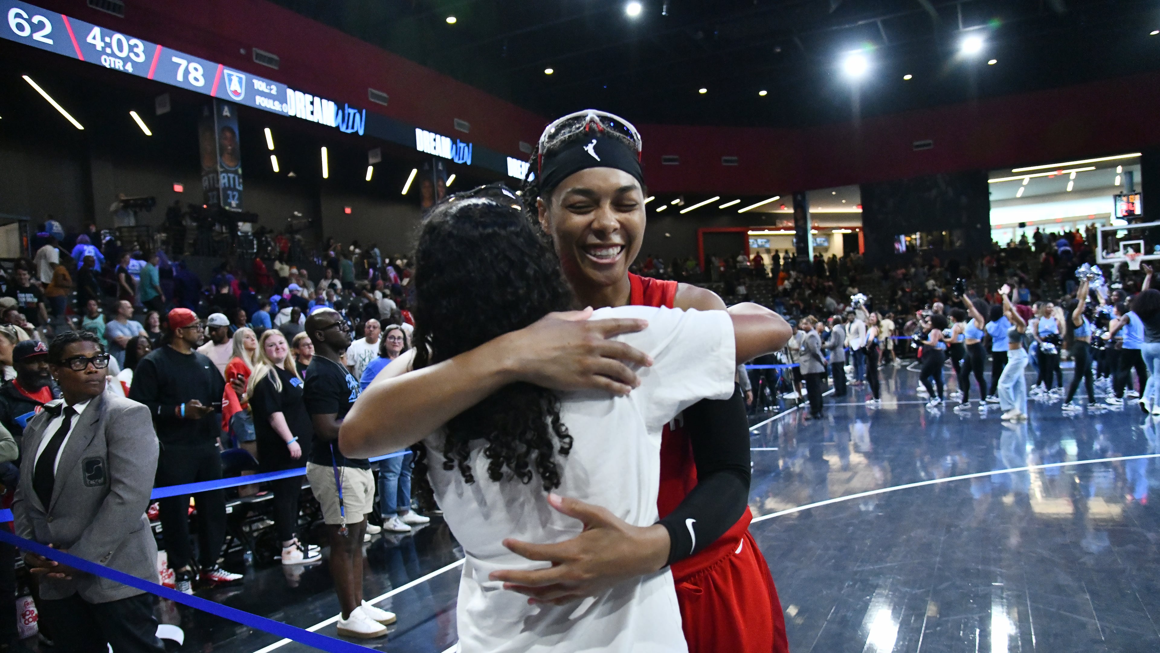 Atlanta Dream guard Allisha Gray (15) celebrates with a fan after Atlanta Dream beat New York Liberty during a WNBA basketball game at Gateway Center Arena, Saturday, August 23, 2025, in Atlanta. Atlanta Dream won 78-62 over New York Liberty. (Hyosub Shin / AJC)