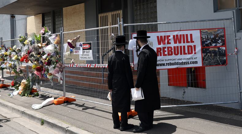 People gather outside the Adass Israel Synagogue, Dec. 9, 2024, after a firebombing in Melbourne, Australia. (Con Chronis/AAP Image via AP)