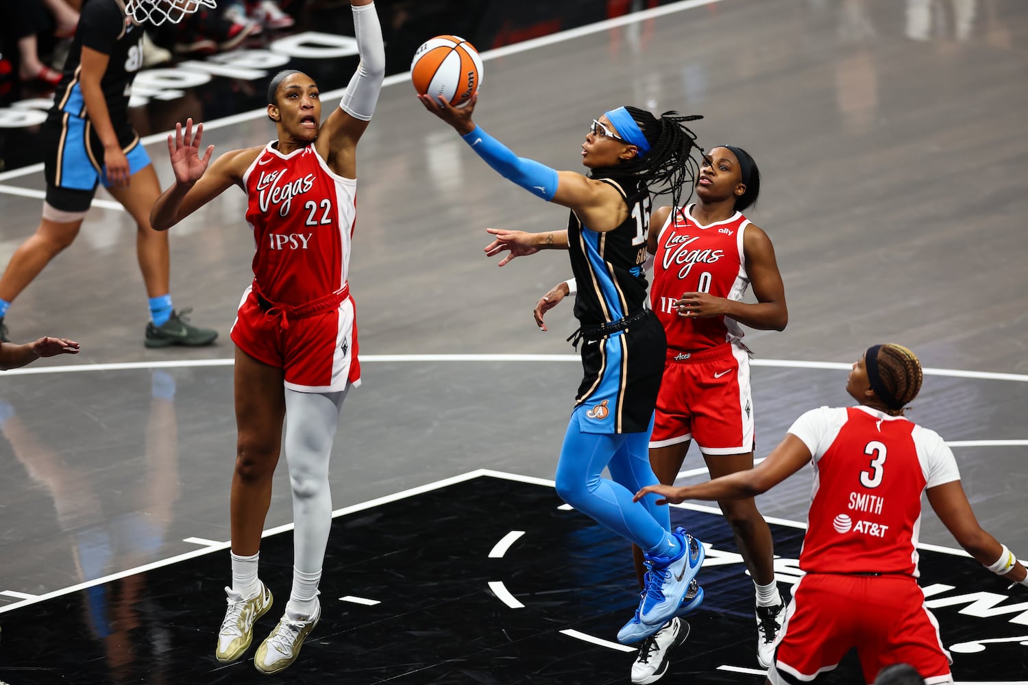 Atlanta Dream guard Allisha Gray (15) shoots against Las Vegas Aces center A'ja Wilson (22), guard Jackie Young (0) and forward NaLyssa Smith (3) during the second half of a WNBA game at State Farm Arena on Sunday, May 17, 2026, in Atlanta. (Colin Hubbard for the AJC) 