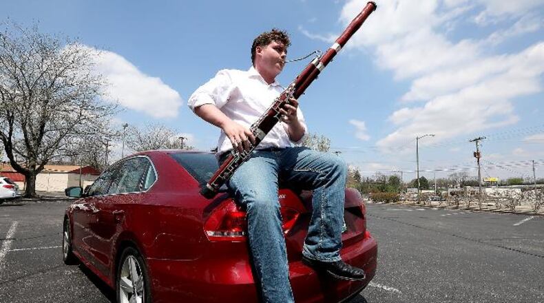 Eric Barga practices his bassoon while sitting on the trunk of his car in the Covenant Presbyterian Church parking lot Wednesday, May 2, 2018 just like he was recently when the Springfield Police Division received a 911 call reporting that he had a gun. Bill Lackey/Springfield News-Sun