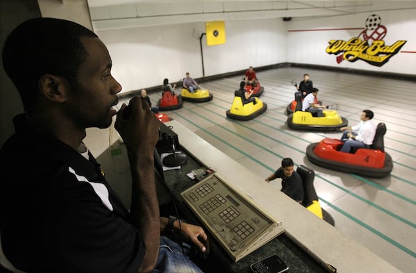 Referee Matthew Clay calls the game from his overhead perch as employees from Credigy, a finacial services business, battle it out in a game of whirlyball during a company team building outting at Whirlyball Atlanta inside Roswell Town Center in Roswell on Wednesday, Nov. 17,  2010.   (Curtis Compton/AJC)